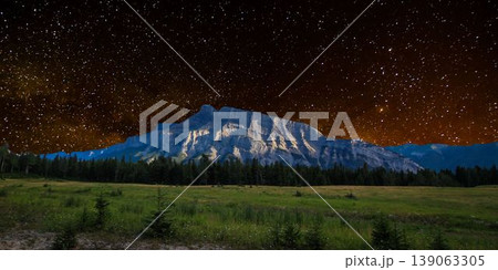 a beautiful night shot of a mountain in the night starry sky 139063305