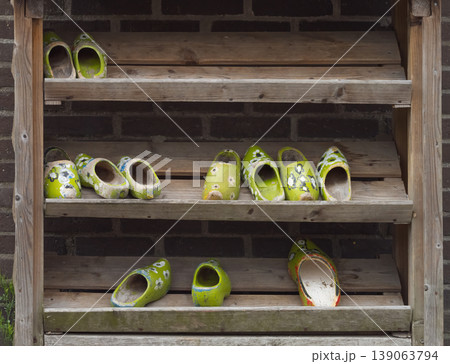 Painted Old Dutch Wooden Clogs on Weathered Rustic Shelf Painted Old Dutch Wooden Clogs on Weathered Rustic Shelf 139063794