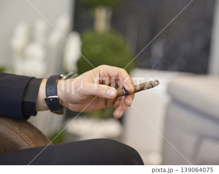 a man smoking a cuban cigar a man smoking a cuban cigar 139064075