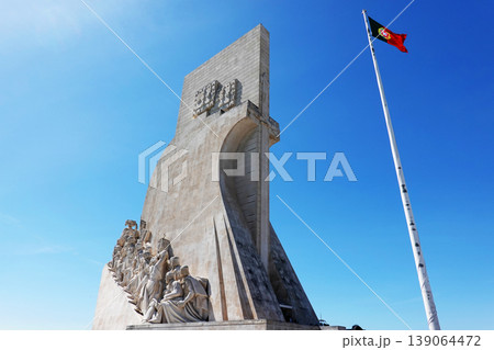 Monument of the Discoveries in Lisbon with Portuguese Flag 139064472