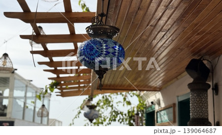 Turkish mosaic lantern under wooden pergola with clear sky background 139064687