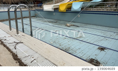 Empty swimming pool with slides, showing off-season status, suitable for background use Empty swimming pool with slides, showing off-season status, suitable for background use 139064689