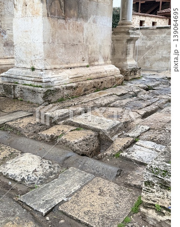 Ancient ruins with stone columns and weathered paths depicting historical architecture background Ancient ruins with stone columns and weathered paths depicting historical architecture background 139064695