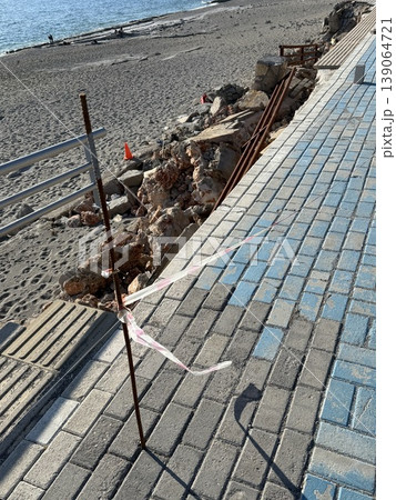 Damaged sidewalk with exposed rebar due to erosion at beach location creating a safety hazard Damaged sidewalk with exposed rebar due to erosion at beach location creating a safety hazard 139064721