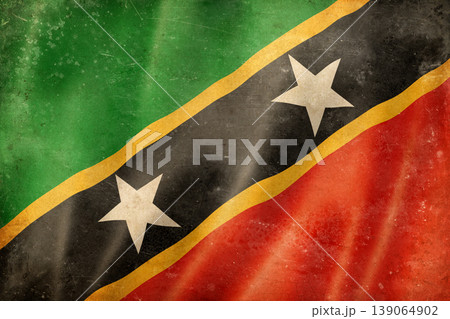 Old vintage flag of Saint Kitts and Nevis, worn and stained Old vintage flag of Saint Kitts and Nevis, worn and stained 139064902