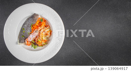 Healthy seafood dish with fish fillet and fresh vegetable salad on plate top view copy space Healthy seafood dish with fish fillet and fresh vegetable salad on plate top view copy space 139064917