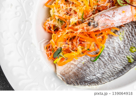 Grilled dorado fish fillet with fresh vegetable salad and grated cheese close up Grilled dorado fish fillet with fresh vegetable salad and grated cheese close up 139064918