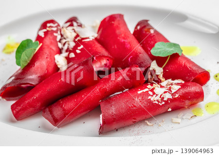 Beetroot rolls with feta cheese healthy vegetarian appetizer on white plate close up Beetroot rolls with feta cheese healthy vegetarian appetizer on white plate close up 139064963
