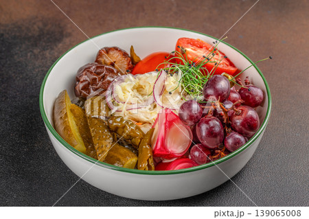 Assorted pickled vegetables and grapes in bowl on table 139065008