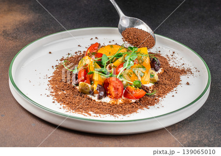 Vegetable salad plating with crumble topping spoon action 139065010