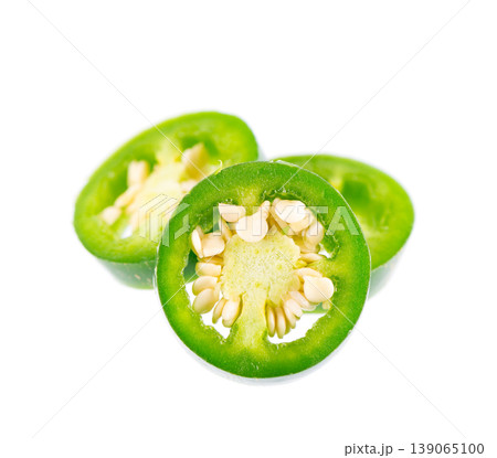 Fresh jalapeno pepper isolated on white background. Slices of green hot serrano pepper. Clipping path. Fresh jalapeno pepper isolated on white background. Slices of green hot serrano pepper. Clipping path. 139065100