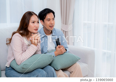 Young asian couple sitting on sofa in living room at home. 139065660