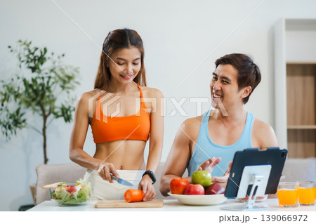 Fit couple enjoys healthy fruit breakfast after yoga training. fitness, nutrition, home lifestyle. Fit couple enjoys healthy fruit breakfast after yoga training. fitness, nutrition, home lifestyle. 139066972