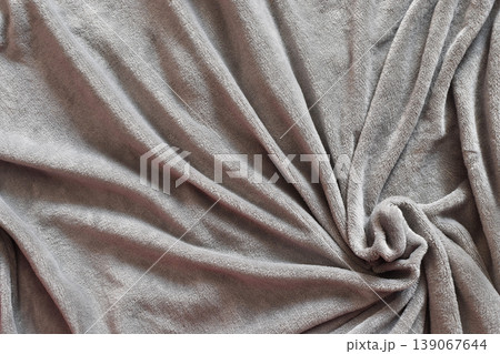 Taupe plush fleece fabric texture. Swirled folds of soft microfiber blanket. 139067644