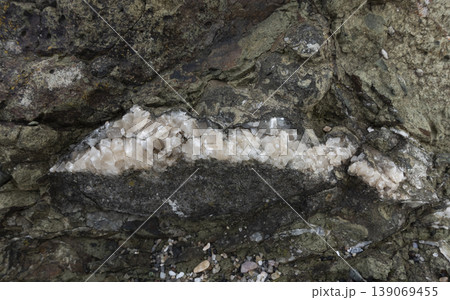 Crack in rock filled with quartz crystals Crack in rock filled with quartz crystals 139069455