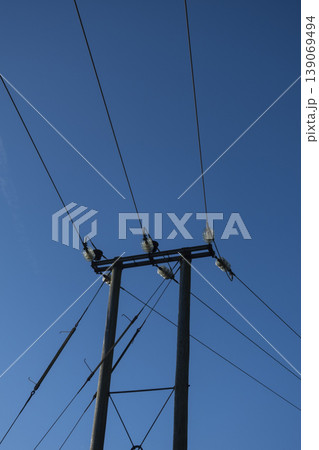 Electric power line pole against clear blue sky Electric power line pole against clear blue sky 139069494