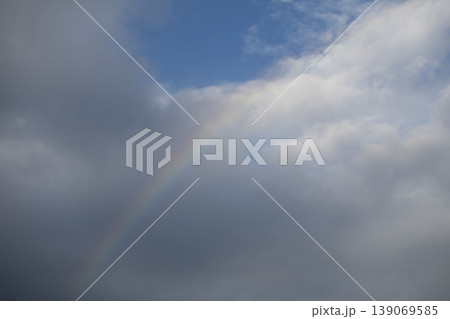 Dramatic cloudy sky with faint rainbow 139069585