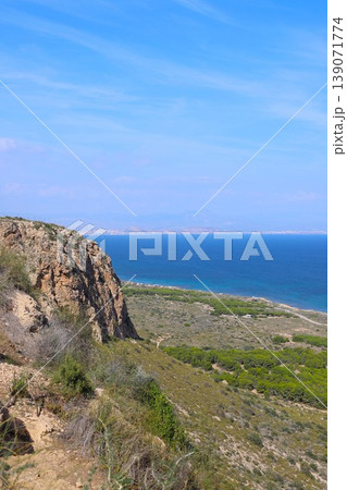 Mediterranean Sea panorama from a rocky cliff overlooking lush green vegetation and the deep blue ocean Mediterranean Sea panorama from a rocky cliff overlooking lush green vegetation and the deep blue ocean 139071774