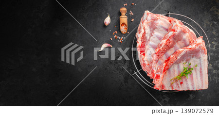 pork ribs raw rack on grill with garlic salt herbs dark background copy space 139072579