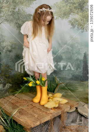 Child girl holding tulips with ducklings, spring portrait with soft green background Child girl holding tulips with ducklings, spring portrait with soft green background 139072606