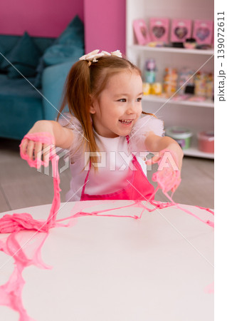 Little girl playing with slime indoors, creative sensory activity for children Little girl playing with slime indoors, creative sensory activity for children 139072611