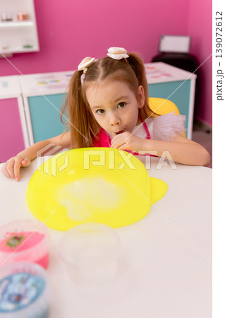 Little girl playing with slime indoors, creative sensory activity for children Little girl playing with slime indoors, creative sensory activity for children 139072612