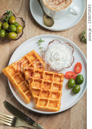 Crunchy waffle fries with sour cream dip served in a basket Crunchy waffle fries with sour cream dip served in a basket 139072683