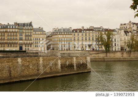 Iconic Parisian architecture lining the River Seine under an overcast sky, representing European travel and urban life 139072953