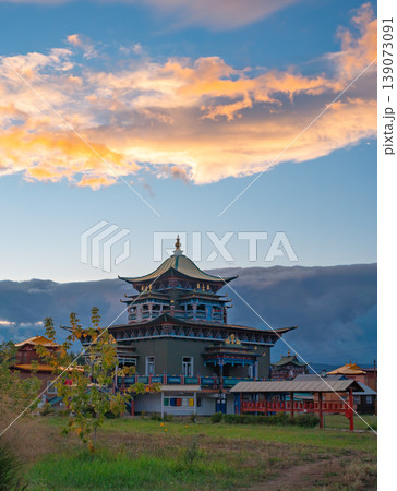 Vibrant Datsan monastery building under a colorful sky during evening light in a rural setting Vibrant Datsan monastery building under a colorful sky during evening light in a rural setting 139073091