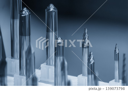Close-up of a high-precision taper flat nose end mill tool in a modern industrial setting. Close-up of a high-precision taper flat nose end mill tool in a modern industrial setting. 139073798