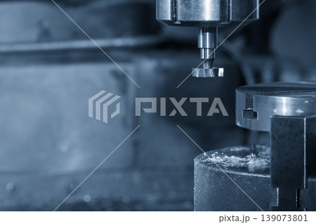 Close-up of a high-precision T-slot tool cutting a slot in a metal plate on an NC milling machine. 139073801