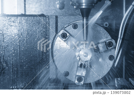 Advanced multi-axis CNC milling machine precision cutting a complex turbine component in a high-tech facility. Advanced multi-axis CNC milling machine precision cutting a complex turbine component in a high-tech facility. 139073802