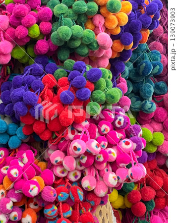 Colourful woollen pompoms, Jujuy, Argentina.Woven textures, wallpaper 139073903