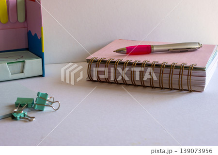 Modern office stationery showcasing a structured workspace with a notebook, pen, and paper clips.Ideal for students, freelancers, and small business owners Modern office stationery showcasing a structured workspace with a notebook, pen, and paper clips.Ideal for students, freelancers, and small business owners 139073956