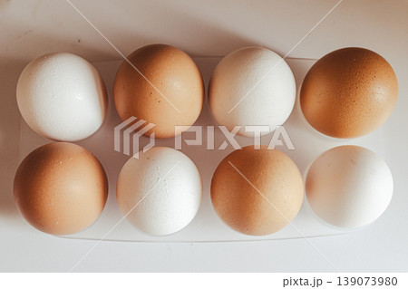 Eight brown and white chicken eggs in an egg organizer tray highlighting healthy eating habits and sustainable protein sources Eight brown and white chicken eggs in an egg organizer tray highlighting healthy eating habits and sustainable protein sources 139073980