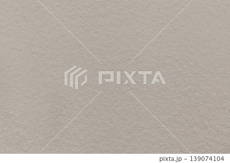 Cool beige textured paper background with subtle grain surface and soft structure. Greige backdrop, macro 139074104