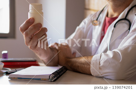 Close-up photo of a doctor explaining the use of prescribed medicine. Close-up photo of a doctor explaining the use of prescribed medicine. 139074201