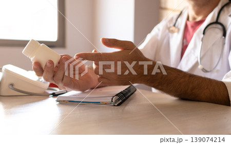 Close-up photo of a doctor giving directions about prescribed vitamins. Close-up photo of a doctor giving directions about prescribed vitamins. 139074214