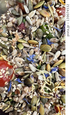 Phone photo of a vegetable salad topped with grains and dried flowers. Healthy gourmet dish showing vibrant colors, texture, and creative plating. Phone photo of a vegetable salad topped with grains and dried flowers. Healthy gourmet dish showing vibrant colors, texture, and creative plating. 139074532