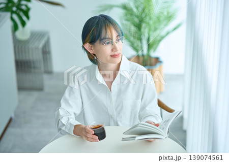 部屋の窓辺で本を読む女性 部屋の窓辺で本を読む女性 139074561