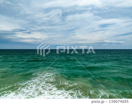 Aerial flying drone view seashore waves water surface texture in sunny tropical ocean at Phuket island Thailand 139074895