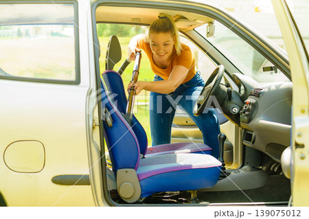 Cleaning car interior with vacuum cleaner Cleaning car interior with vacuum cleaner 139075012