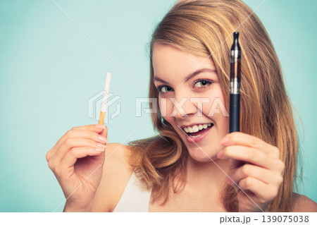 Girl with normal and electronic cigarette. Girl with normal and electronic cigarette. 139075038