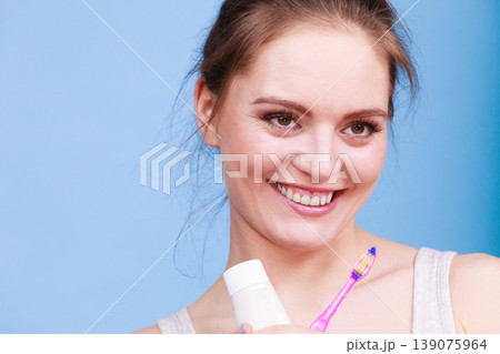Woman holds toothbrush and paste for teeth cleaning Woman holds toothbrush and paste for teeth cleaning 139075964