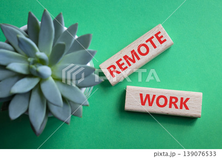 REMOTE WORK symbol. Concept word REMOTE WORK on wooden blocks. Beautiful green background with succulent plant. Business and REMOTE WORK concept. Copy space 139076533