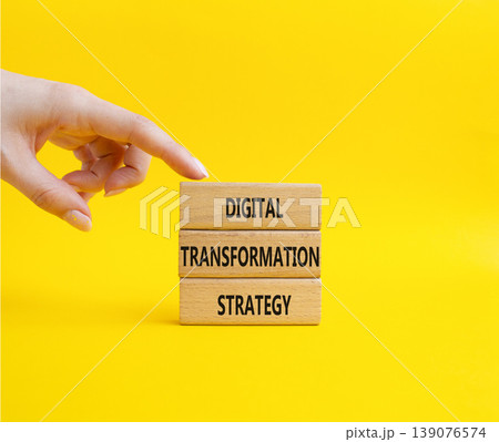 Digital Transformation Strategy symbol. Concept word Digital Transformation Strategy on wooden blocks. Businessman hand. Beautiful yellow background. Business and Digital Transformation Strategy. Copy Digital Transformation Strategy symbol. Concept word Digital Transformation Strategy on wooden blocks. Businessman hand. Beautiful yellow background. Business and Digital Transformation Strategy. Copy 139076574