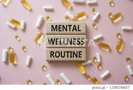 MENTAL WELLNESS ROUTINE symbol. Concept words MENTAL WELLNESS ROUTINE on wooden blocks. Beautiful pink background with pills. Healthcare and MENTAL WELLNESS ROUTINE concept. Copy space. MENTAL WELLNESS ROUTINE symbol. Concept words MENTAL WELLNESS ROUTINE on wooden blocks. Beautiful pink background with pills. Healthcare and MENTAL WELLNESS ROUTINE concept. Copy space. 139076607