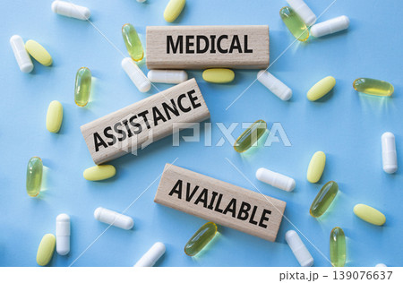MEDICAL ASSISTANCE AVAILABLE symbol. Concept words MEDICAL ASSISTANCE AVAILABLE on wooden blocks. Beautiful blue background with pills. Healthcare and MEDICAL ASSISTANCE AVAILABLE concept. Copy space. MEDICAL ASSISTANCE AVAILABLE symbol. Concept words MEDICAL ASSISTANCE AVAILABLE on wooden blocks. Beautiful blue background with pills. Healthcare and MEDICAL ASSISTANCE AVAILABLE concept. Copy space. 139076637
