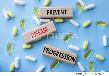 Prevent Disease Progression symbol. Concept words Prevent Disease Progression on wooden blocks. Beautiful blue background with pills. Healthcare and Prevent Disease Progression concept. Copy space. Prevent Disease Progression symbol. Concept words Prevent Disease Progression on wooden blocks. Beautiful blue background with pills. Healthcare and Prevent Disease Progression concept. Copy space. 139076640