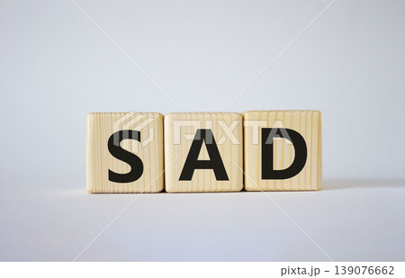 Sad symbol. Wooden cubes with words Sad. Beautiful white background. Business and Sad concept. Copy space. Sad symbol. Wooden cubes with words Sad. Beautiful white background. Business and Sad concept. Copy space. 139076662